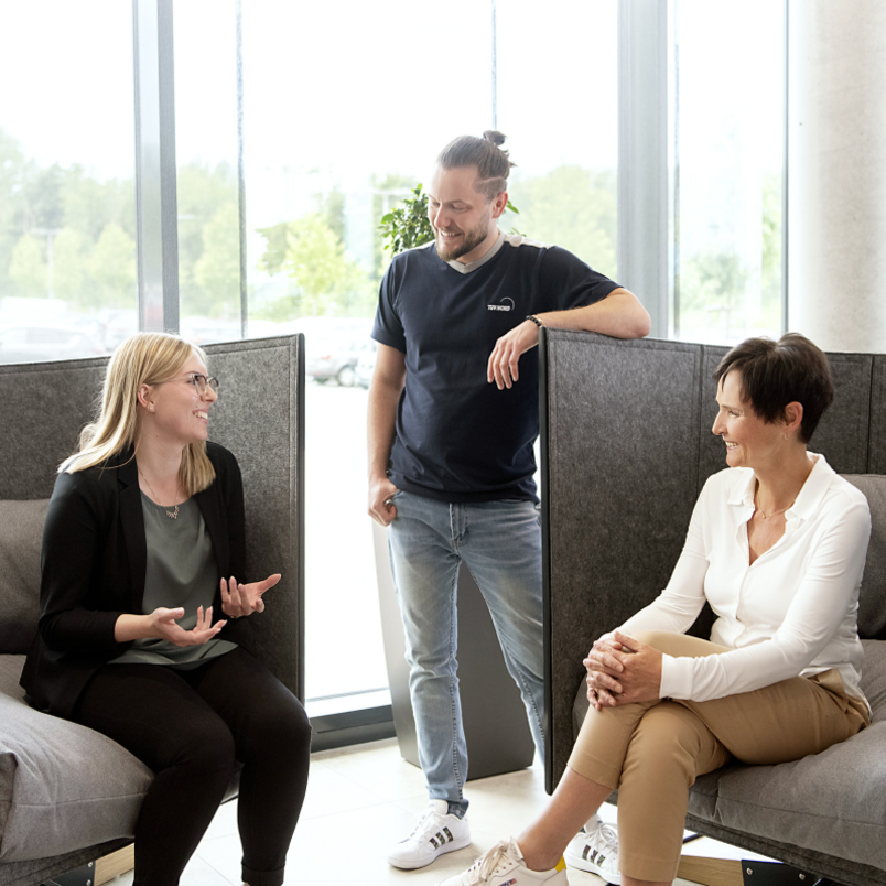 Three colleagues sitting together and talking