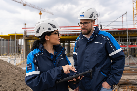 Two engineers talking in front of a building