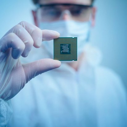 Man shows a semiconductor.